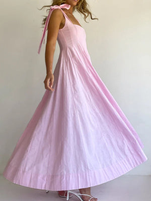 Pink bow-tie shoulder maxi dress with a full skirt and square neckline.