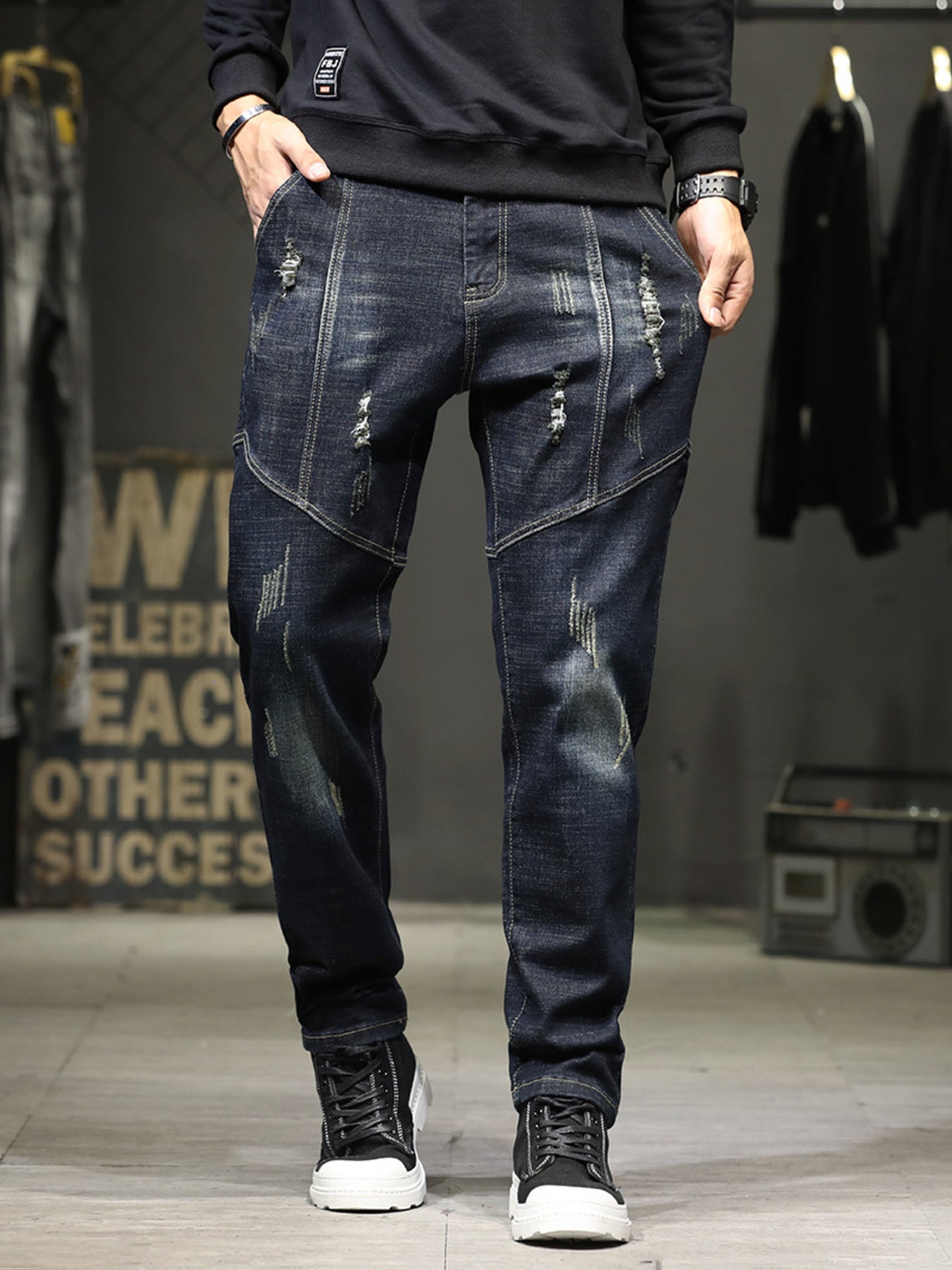 Men's dark wash distressed denim jeans with slim fit and detailed stitching.