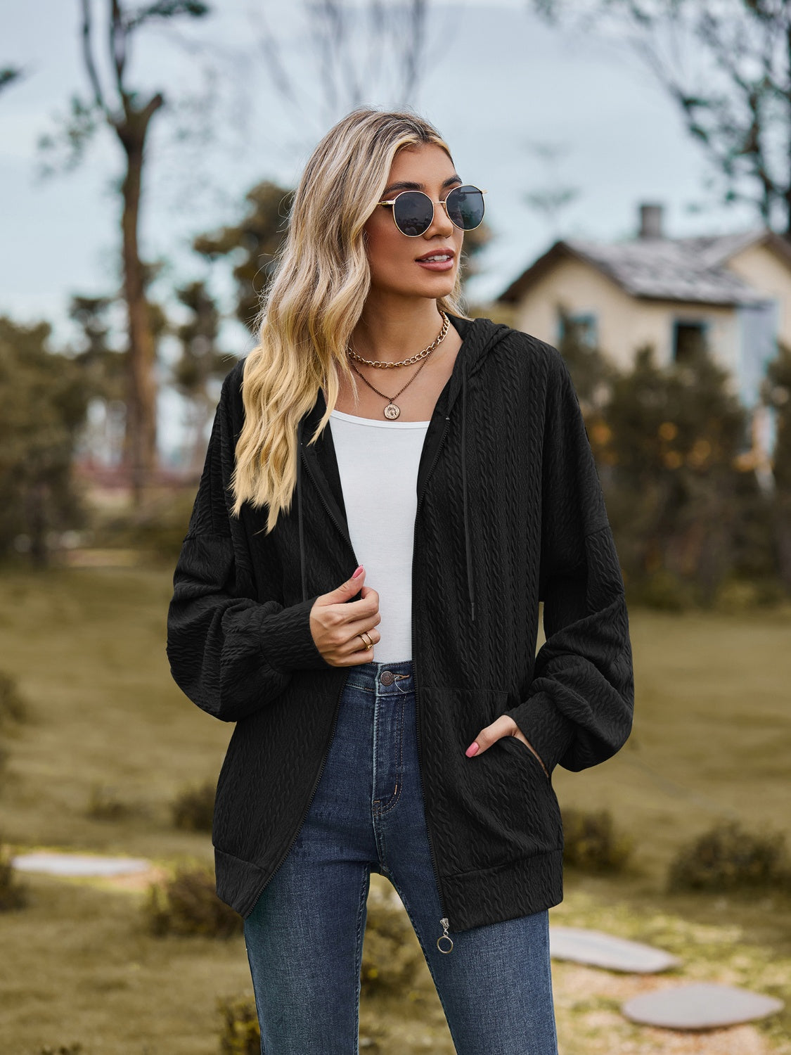 Black textured knit dolman sleeve zip-up hoodie with drawstring hood and pockets.