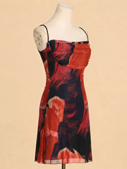 Red and blue abstract print spaghetti strap dress with a ruched bodice.