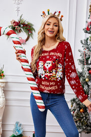 Red acrylic knit sweater with Santa, snowmen, and snowflakes graphic, crew neck, long sleeves.