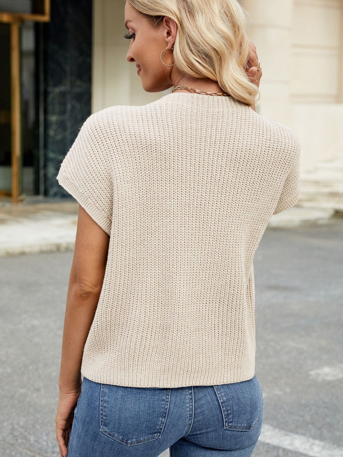 Eggshell knit cap-sleeve top with ribbed texture and a single chest pocket.