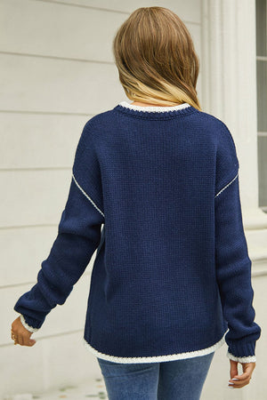 Dark blue acrylic crewneck sweater with white contrast trim and stitching detail.