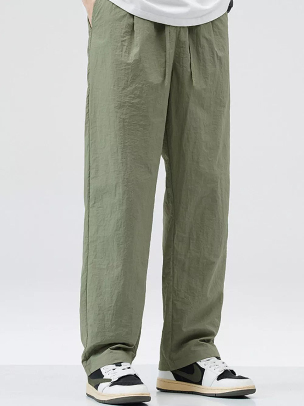 Relaxed fit wide-leg sweatpants in sage green with a crinkled texture.