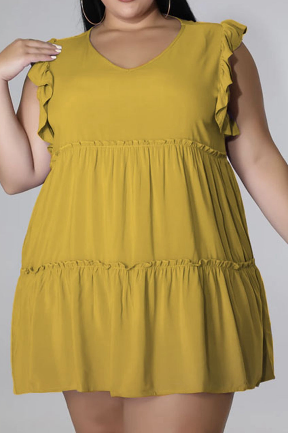 Mustard tiered ruffle babydoll mini dress with flutter sleeves and V-neck.