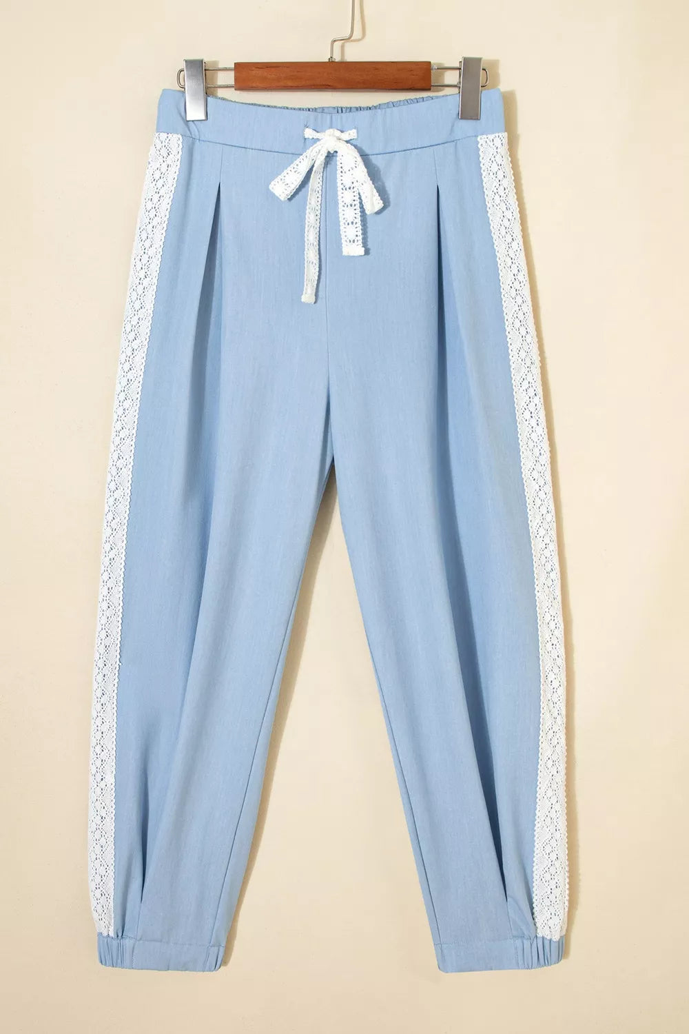 Light blue maternity pants with white lace trim and drawstring detail.
