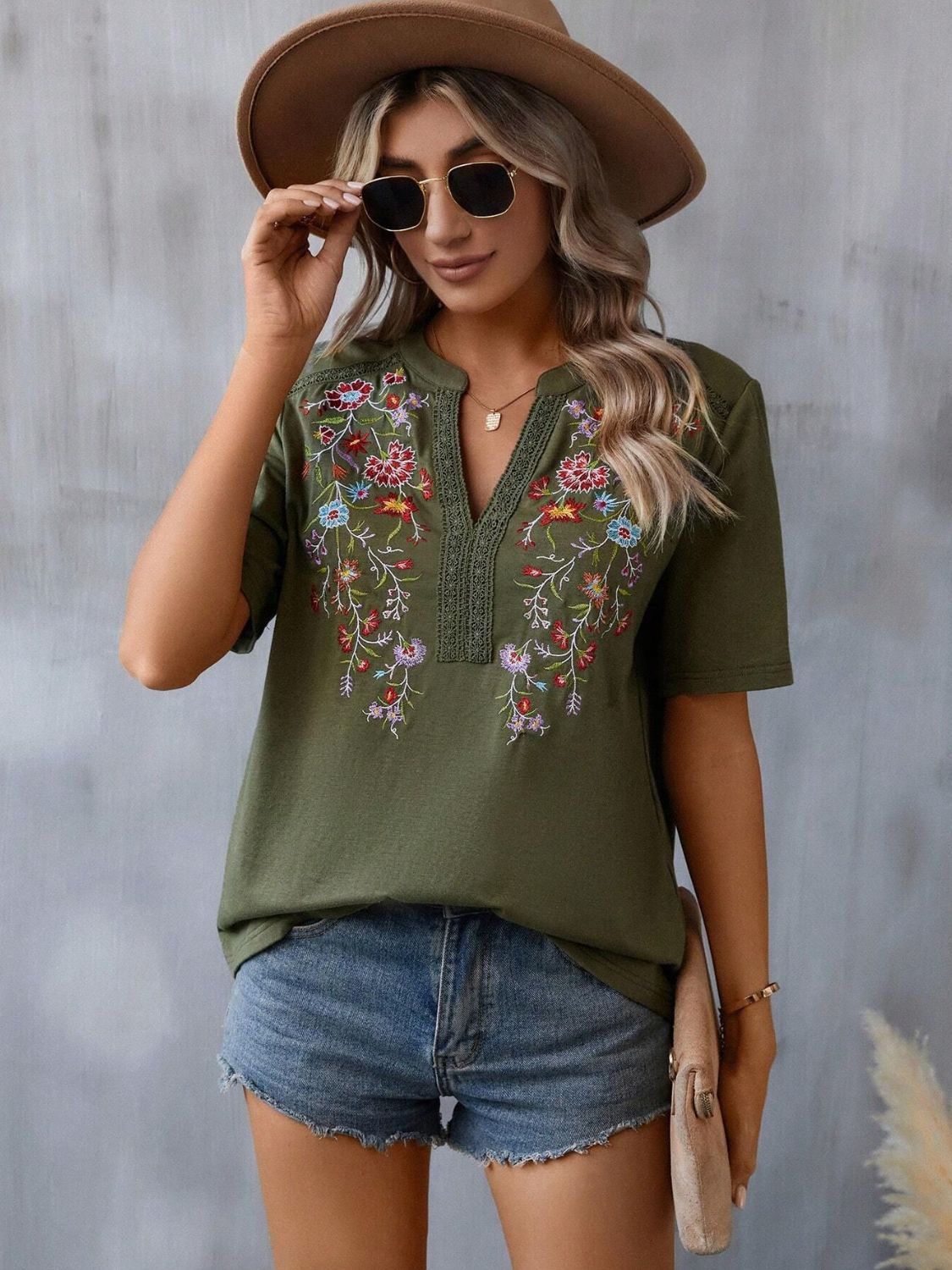 Army green V-neck tee with floral embroidery and crochet trim, short sleeves.