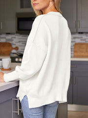 White ribbed-knit relaxed fit sweater with crewneck and dropped shoulders.