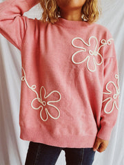 Watermelon pink acrylic knit sweater with white floral outline detail.