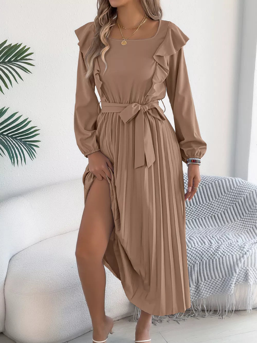 Khaki A-line midi dress with ruffles, square neck, long sleeves, belted waist, and pleated skirt.