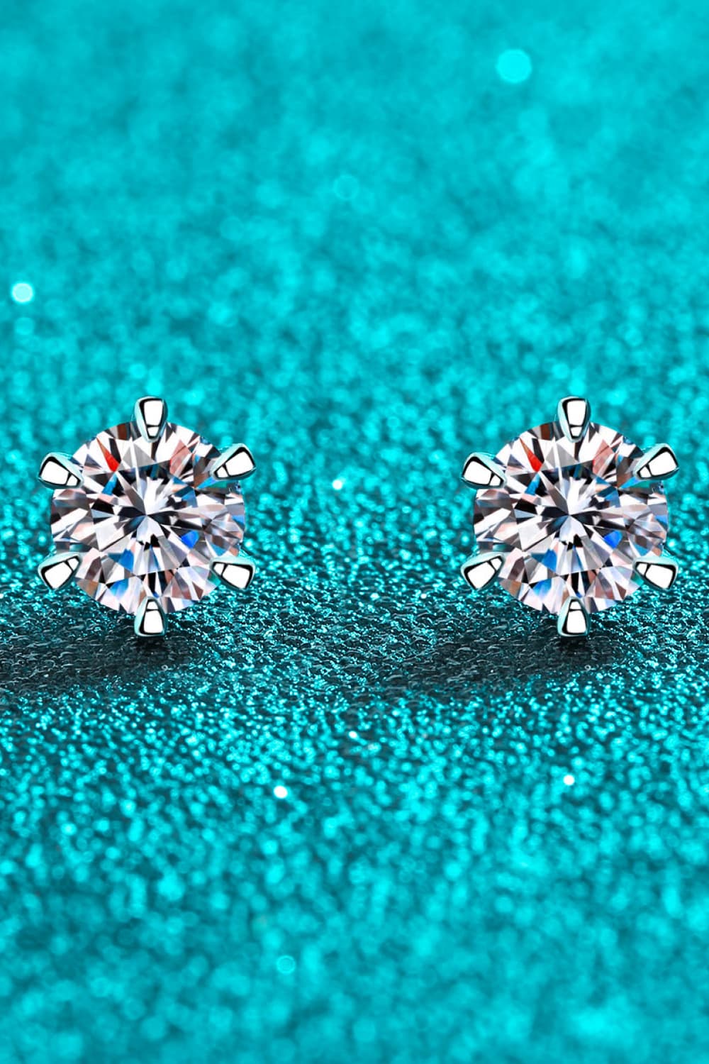 Silver six-prong solitaire stud earrings with clear cubic zirconia stones.