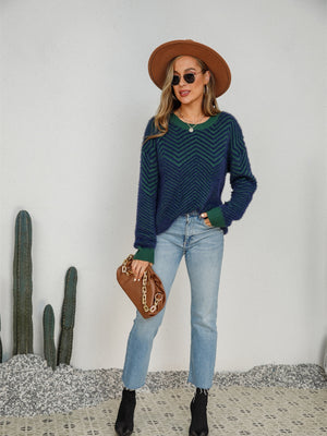 Chevron knit crewneck sweater in dark blue and green with a fuzzy texture.
