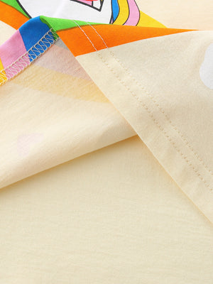 Light yellow cotton t-shirt with rainbow trim and unicorn graphic detail.