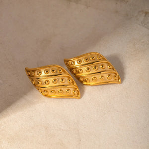 Sculpted gold leaf stud earrings with raised dot pattern, 18K gold-plated.
