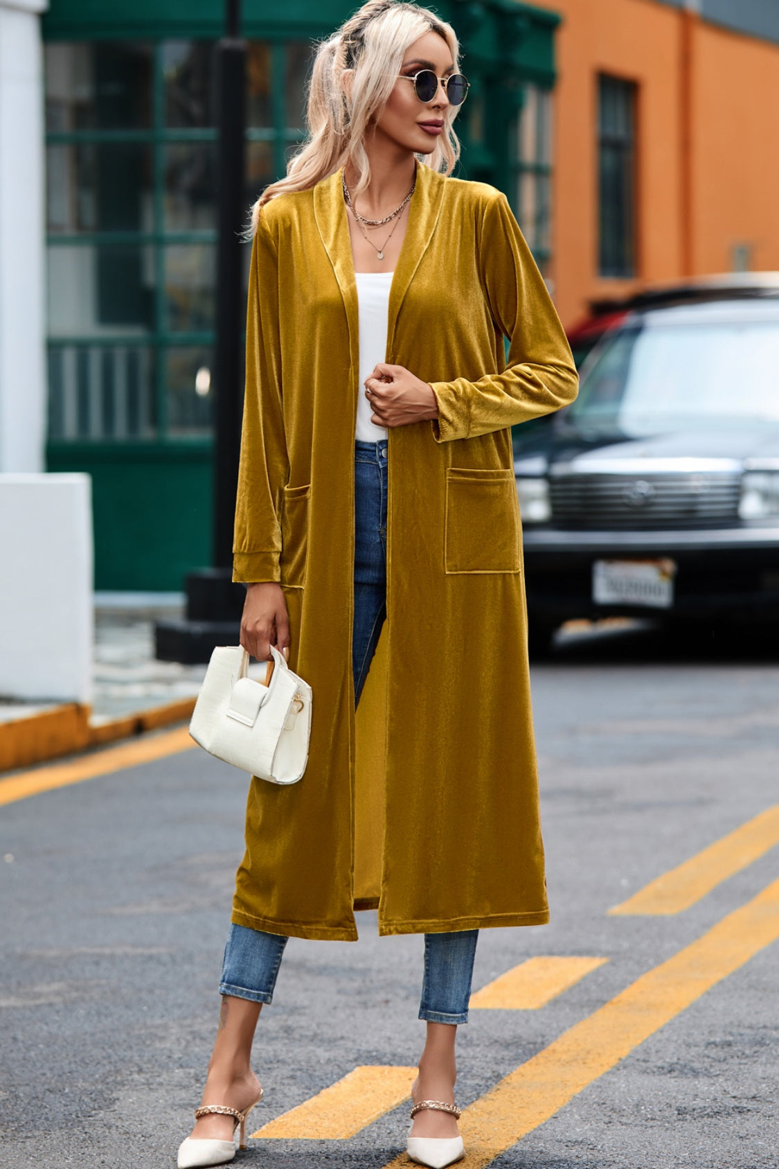Mustard velvet duster coat with open front, long sleeves, and two patch pockets.