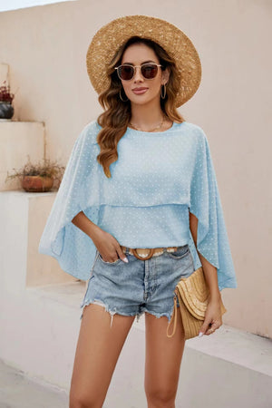 Light blue dotted swiss blouse with cape sleeves and a tiered overlay.