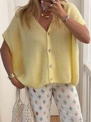Pastel yellow mohair button cardigan with cap sleeves and a V-neck.
