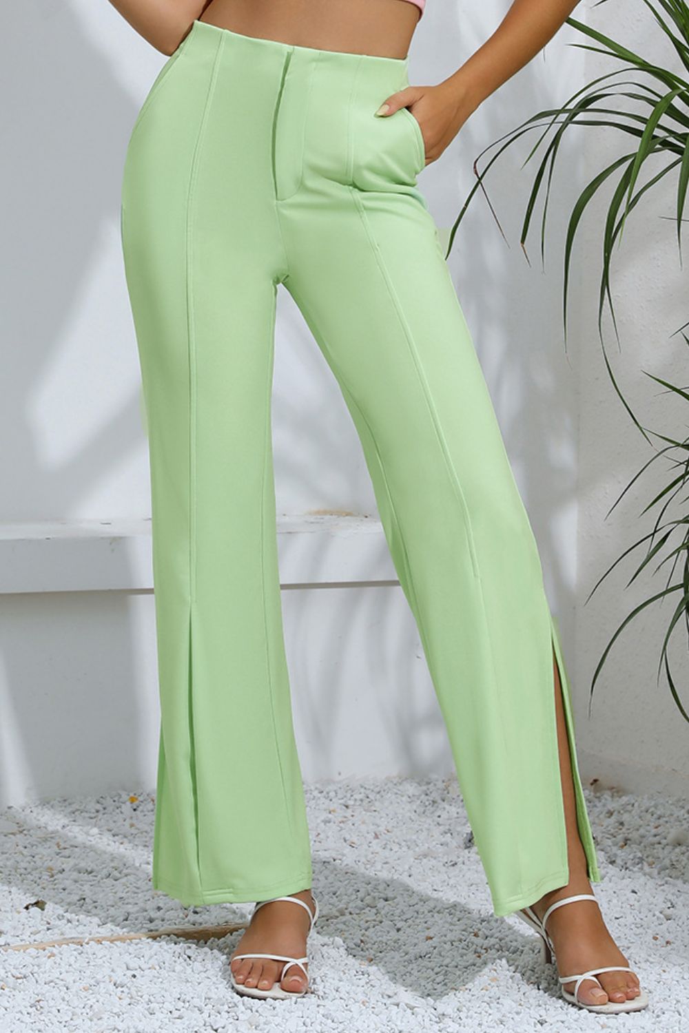 Neon green tailored trousers with split hem detail and a flattering high waist.