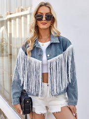 Denim trucker jacket in medium wash with white fringe trim, button front, and collar.
