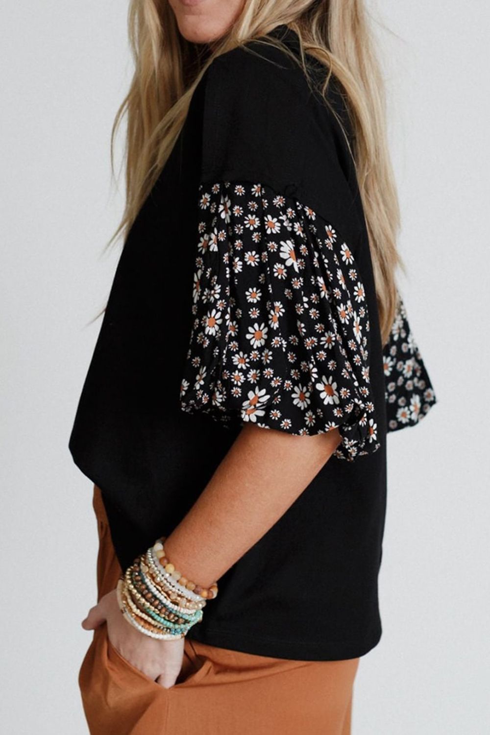 Black t-shirt with daisy print contrast sleeves and a relaxed fit.