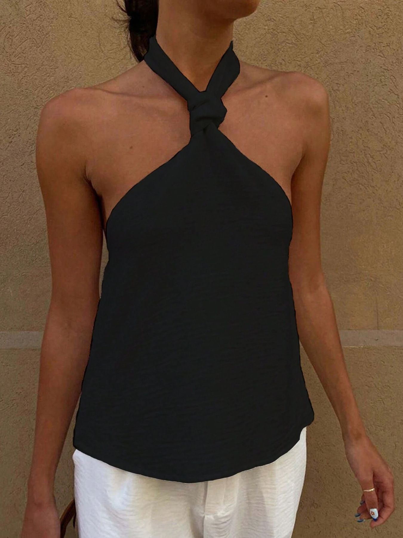Black halter cami with twisted knot detail and backless design