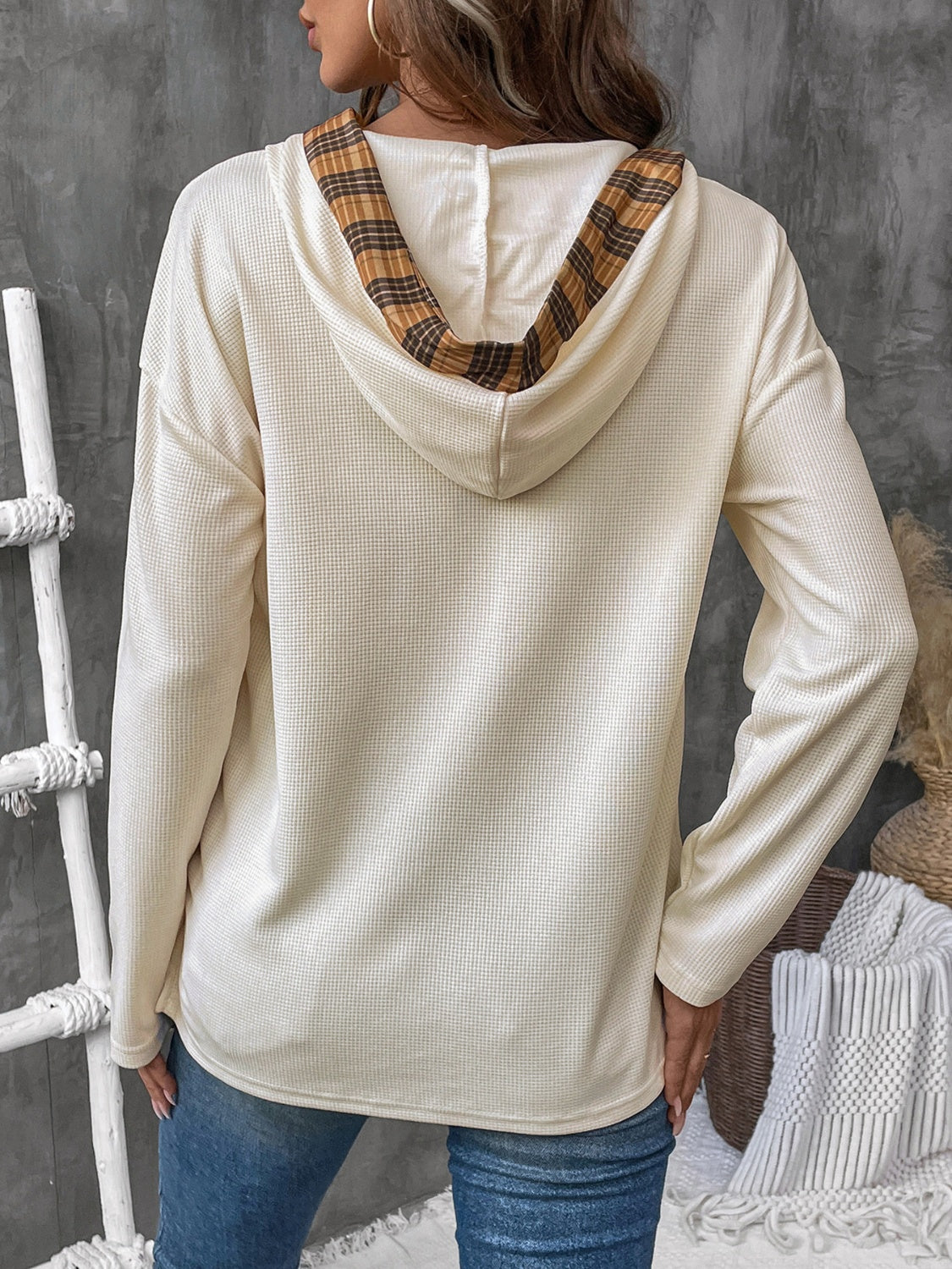 Cream waffle knit henley hooded top with plaid lining detail.