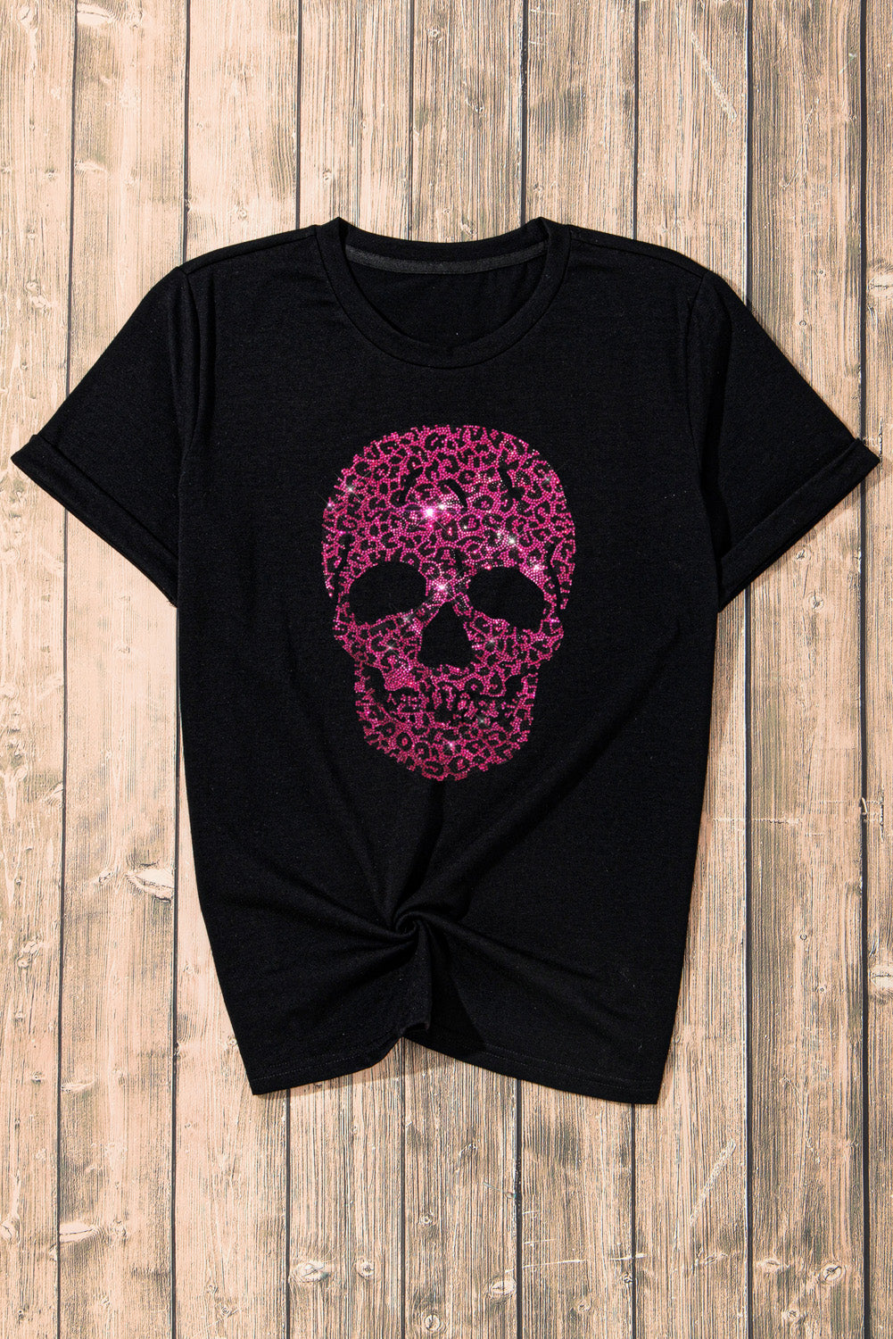 Black t-shirt with a pink leopard print skull graphic embellished with rhinestones.