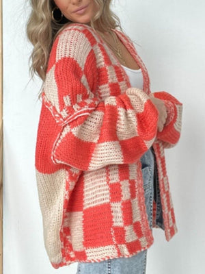 Oversized checkerboard knit cardigan in deep red and beige with balloon sleeves.