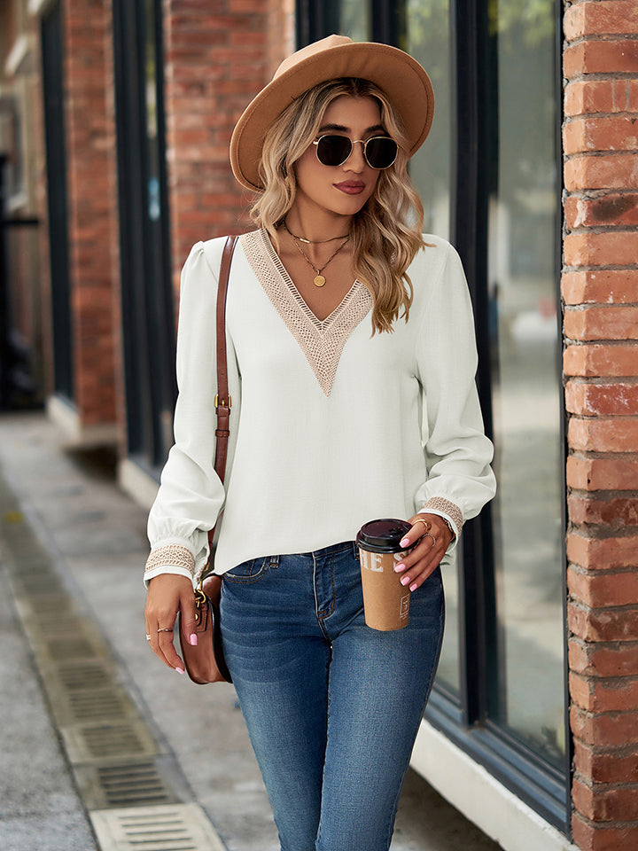 White blouson sleeve top with embroidered trim neckline and cuffs