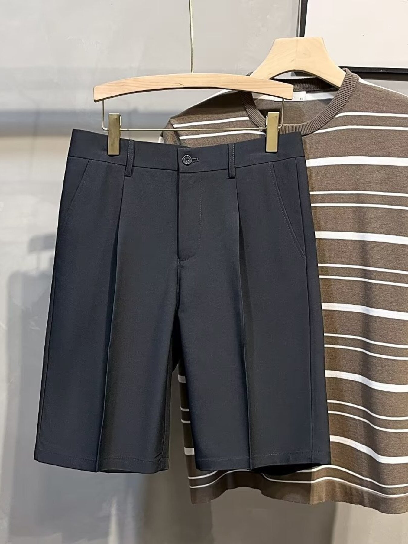Pleated front casual men's chino shorts in dark gray with a button and zip closure.