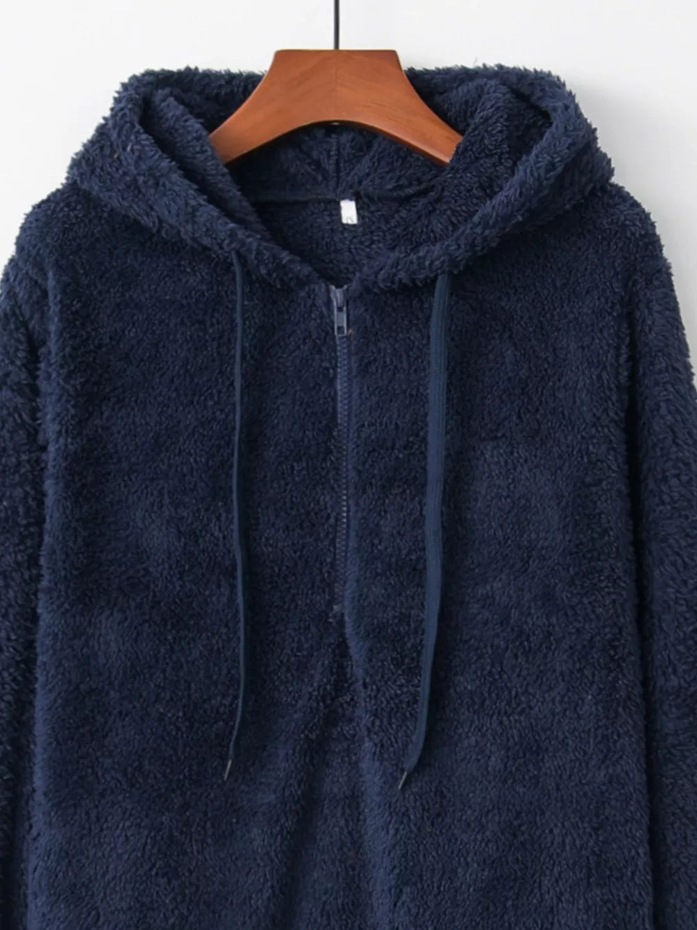 Navy blue fuzzy fleece half-zip hoodie with drawstring and hood.