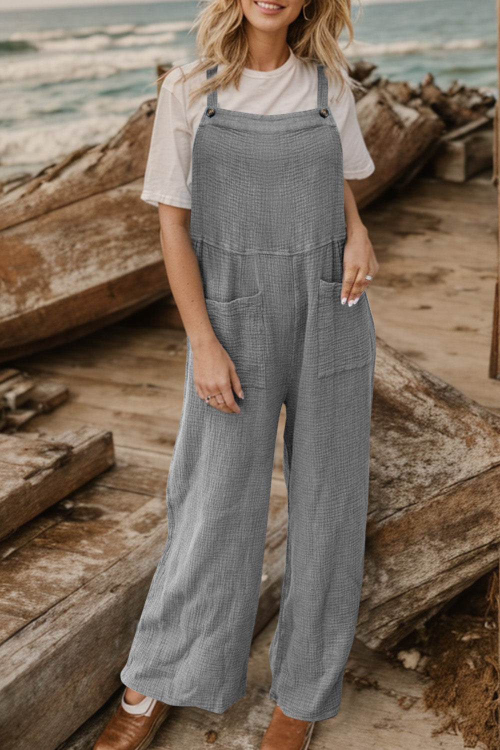 Gray textured cotton overalls with square pockets and wide legs.