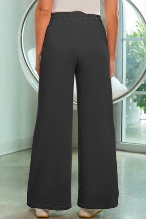 Black palazzo joggers with center seam detail and elastic waistband.