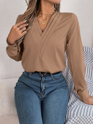 Camel V-neckline blouse with pleated detail and long sleeves.