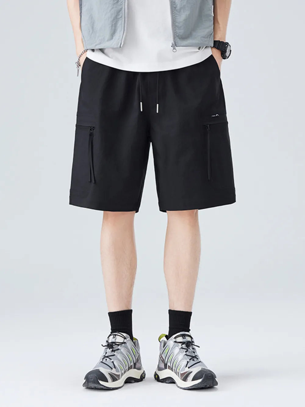 Black cargo shorts with zippered pockets and drawstring waist.