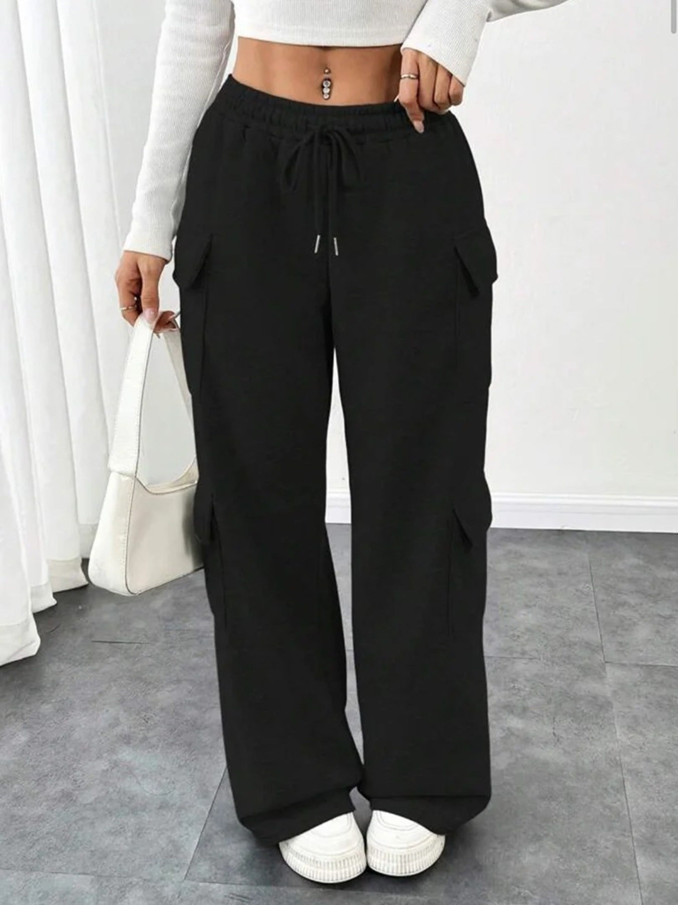 Black relaxed fit cargo pants with drawstring waist and side pockets.