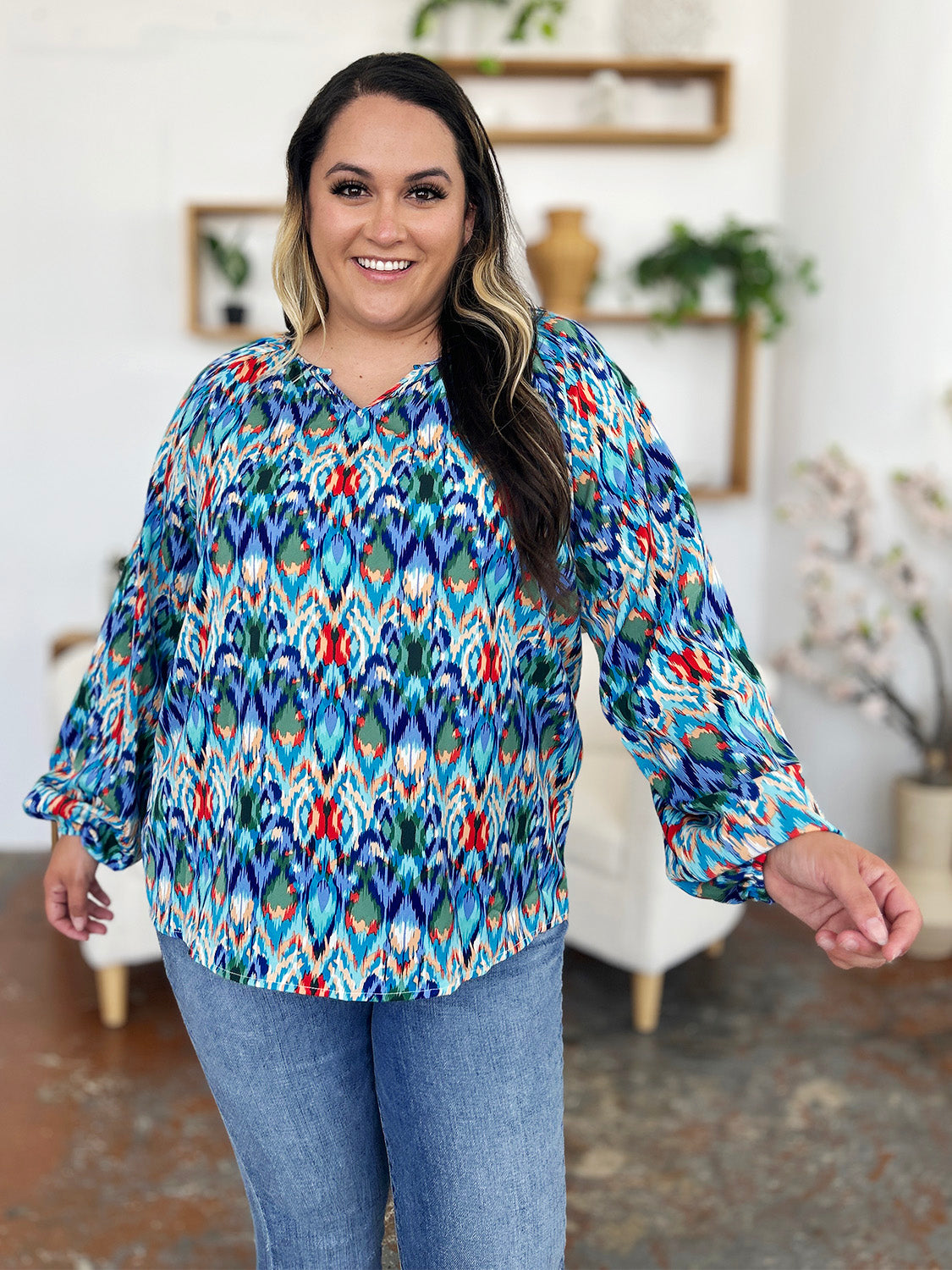 Prismatic ikat blouse in blue with voluminous sleeves and a v-neckline.