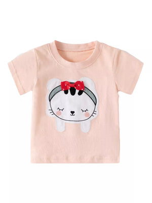 Peach toddler t-shirt with a whimsical cat appliqué featuring a red 3D bow.
