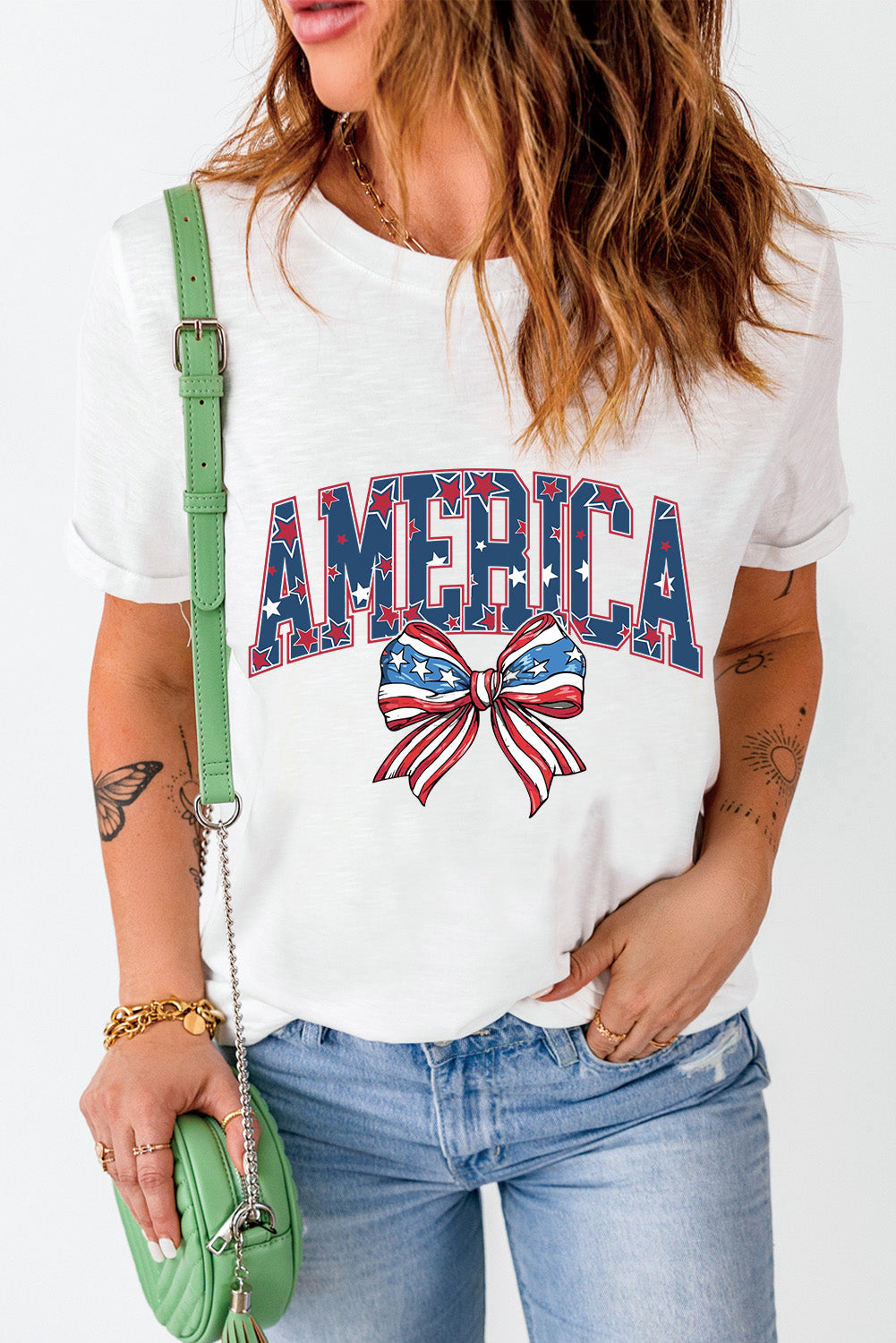White graphic tee with America text and patriotic bow motif.