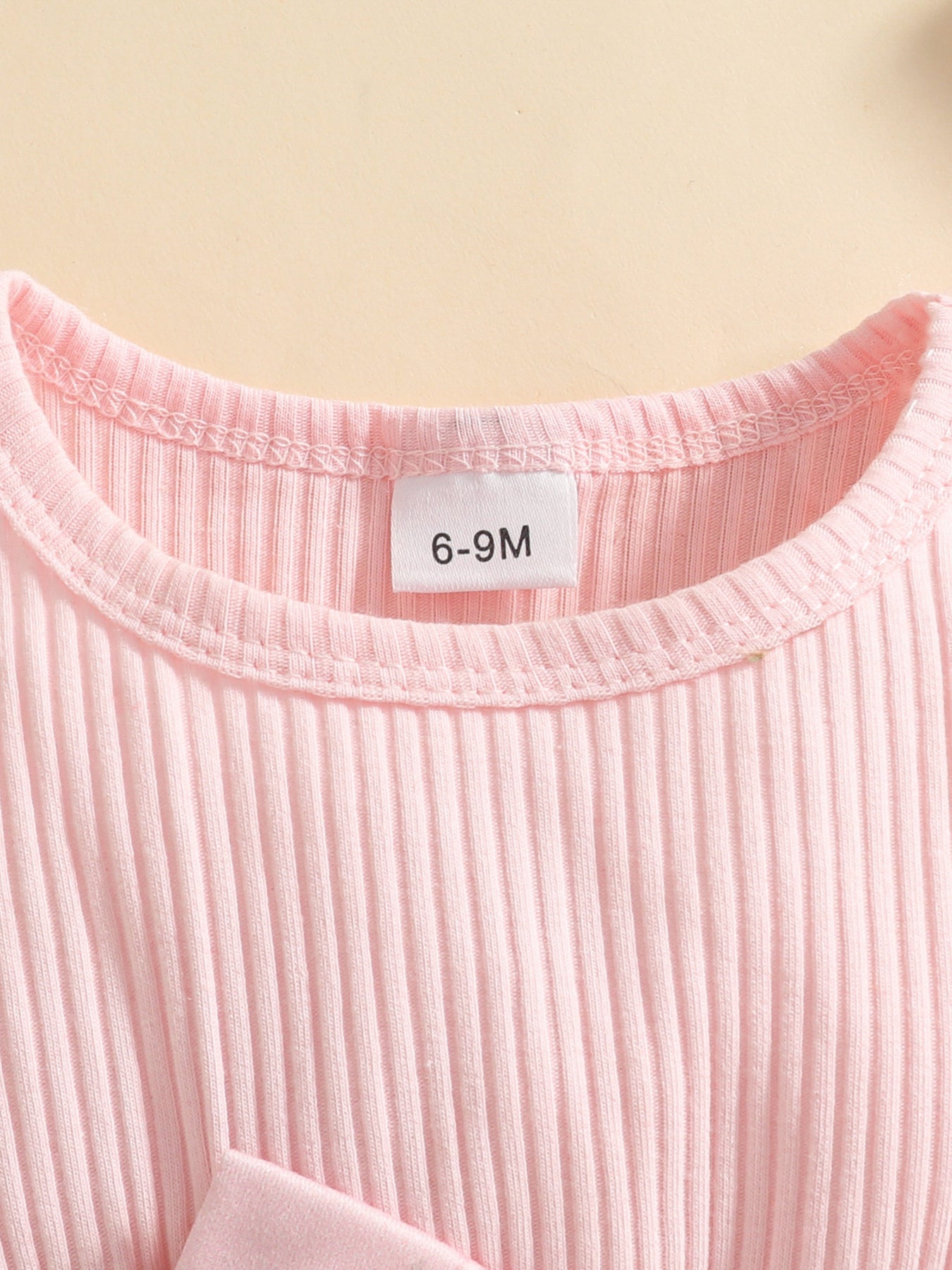 Pink ribbed baby set with a bow detail.