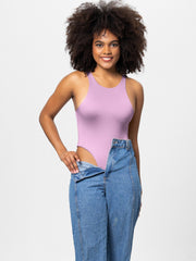 Lilac high cut tank bodysuit with a racerback detail, worn with jeans.