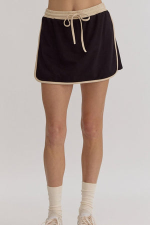 Black sweatshirt and skort set with contrast trim and drawstring waist.