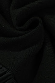 Black ribbed bodice peplum top with a ruffled hem detail.
