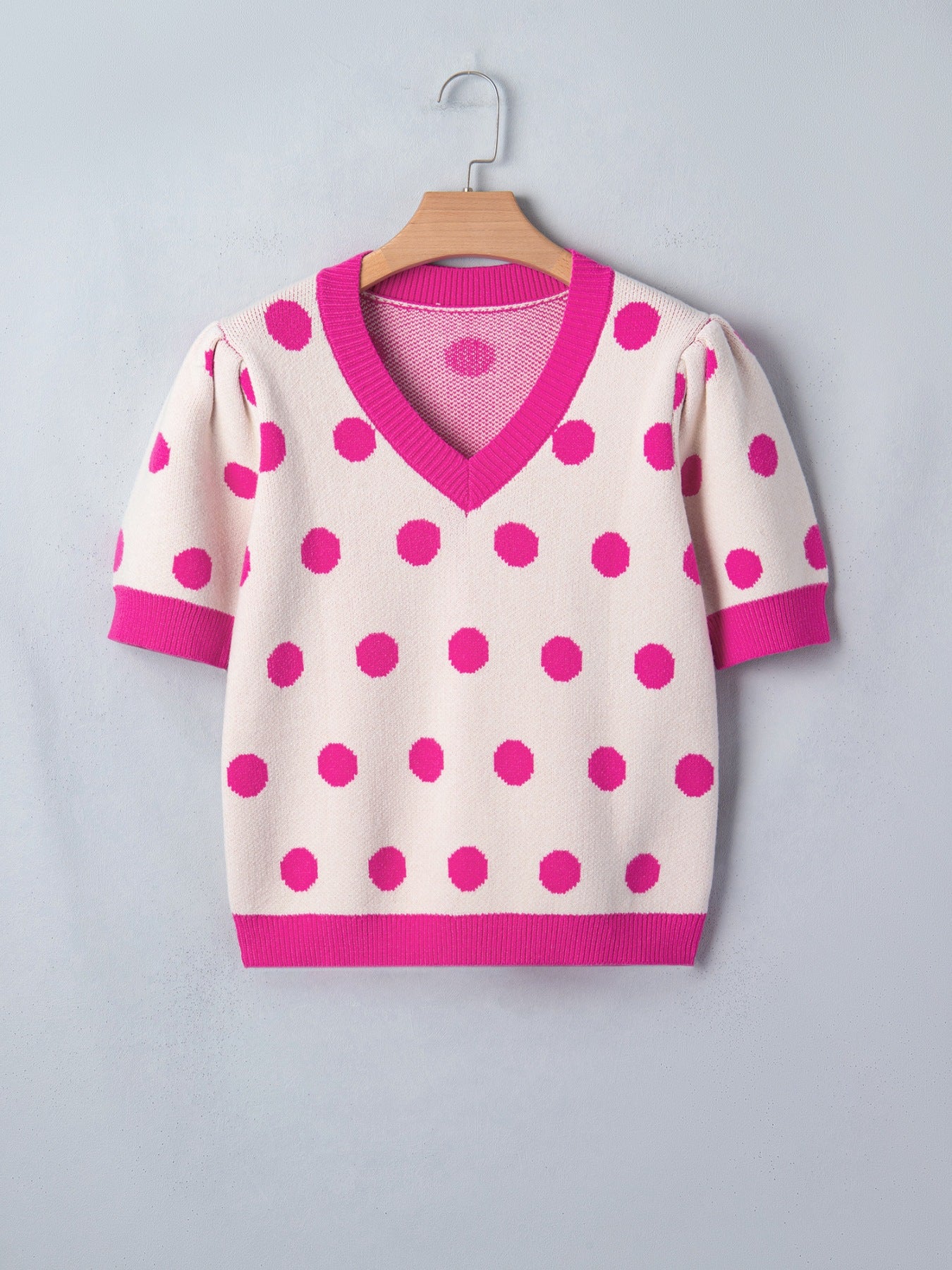 Cream polka dot knit top with hot pink trim and puff sleeves