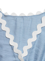Blue maternity romper cover-up with white scalloped trim detail.