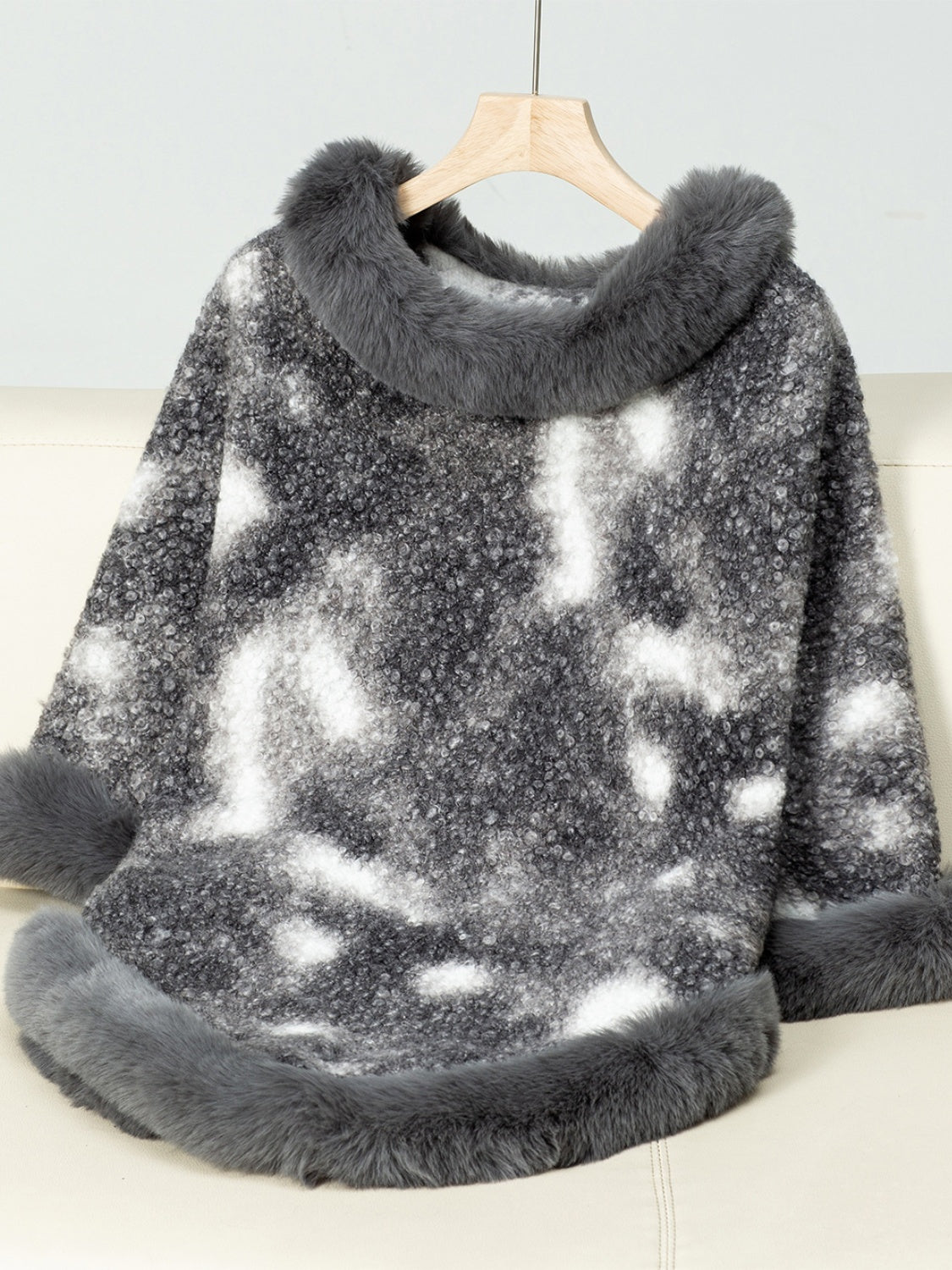 Faux fur trimmed camo poncho in dark gray with a textured knit and fuzzy trim.