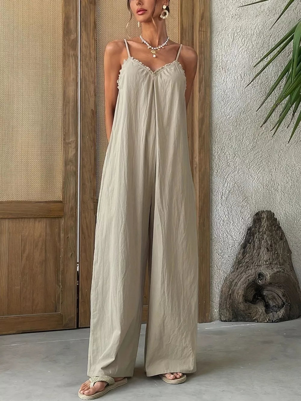 Effortless frill-trimmed sleeveless jumpsuit in beige with wide legs and a flowy fit.