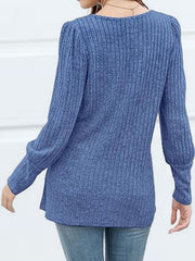 Dusty blue ribbed knit blouse with puff sleeves and button detail.