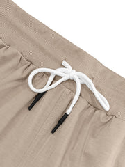 Khaki chino shorts with elastic waistband and white drawstring with black tips.