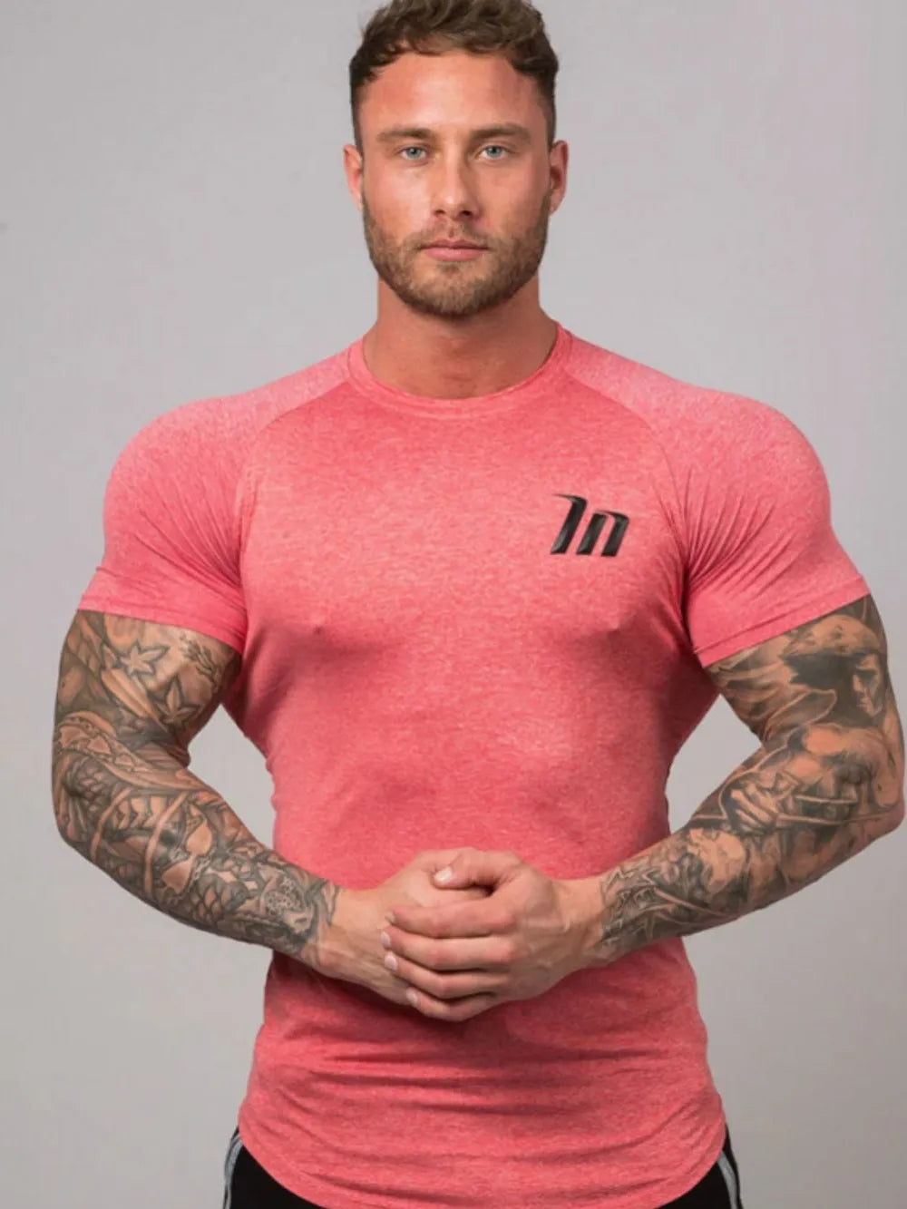 Burnt Coral raglan tee with black logo detail, crew neck, short sleeves, performance fit.